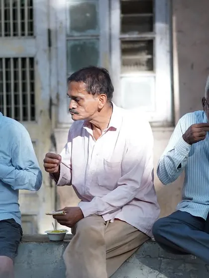 Three men sit together to eat, finding community and nourishment. We dream of a hunger-free world where sharing is a way of life.