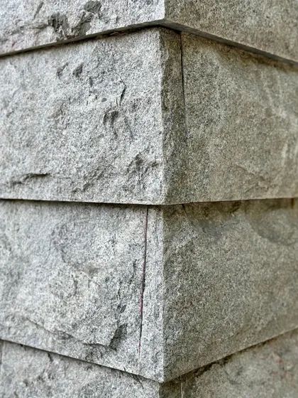 A detailed corner joint of the hand-chiseled stone, showing the precision of the craft.
