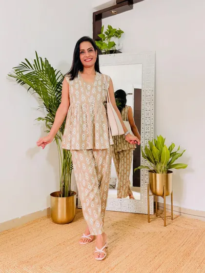 A comfortable and chic beige printed co-ord set from Myntra. This sleeveless peplum-style top with matching pants is great for a casual work day.