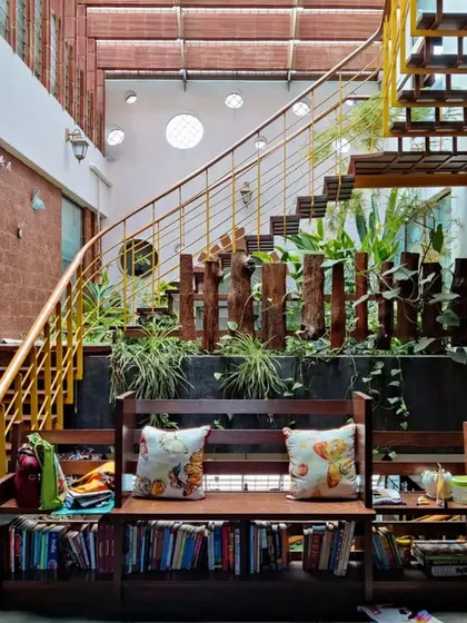 A garden thrives between the flights. This design incorporates a lush indoor garden directly into the staircase structure, bringing life and fresh air into the core of the home and making the journey between floors a refreshing experience.