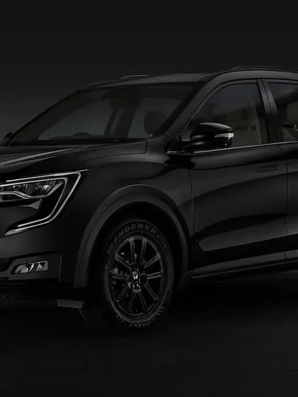A studio shot of the 2024 Mahindra XUV700 in a striking all-black finish. I used subtle lighting to sculpt the car's form and create a powerful, moody atmosphere.