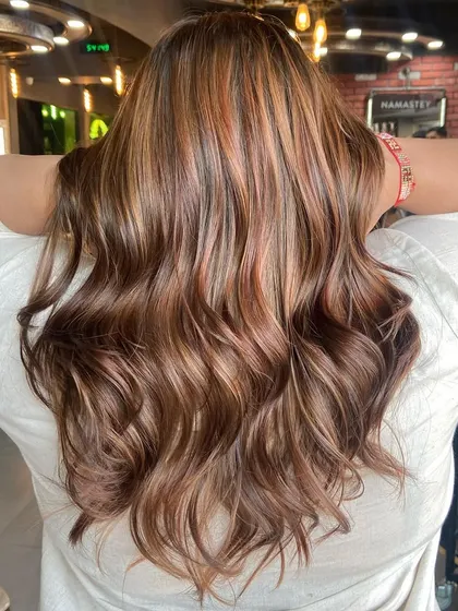 The back view of this honey and caramel dual-tone balayage, showing off the rich, glossy finish achieved without any bleach.