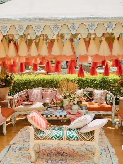 Another view of the royal tent setup, framed by giant paper flowers, adding a touch of whimsy to the elegant decor.