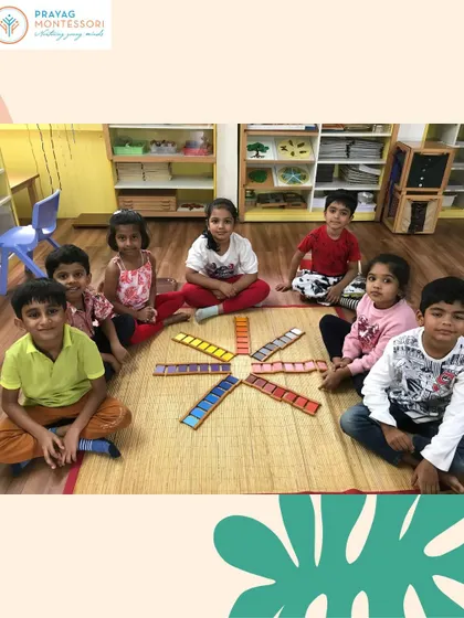 Children working together with the color tablets. This sensorial activity helps refine their visual perception and gives them the vocabulary to describe the world in vibrant detail.