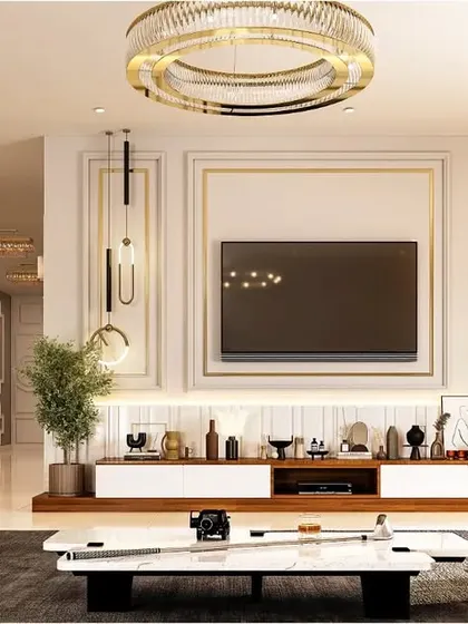 An expansive living room designed for comfort and conversation. The layout features two sofas facing each other, grounded by a large area rug and a modern TV console, all under the soft glow of recessed and pendant lighting.