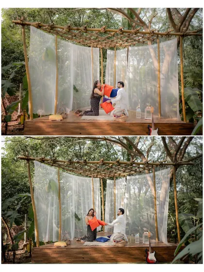 A wide shot of the couple's playful pillow fight in a beautiful outdoor canopy, capturing the full scene and their joyful energy.