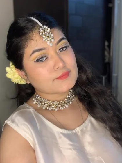 Another angle of the soft yellow makeup, paired with a delicate choker and maang tikka.