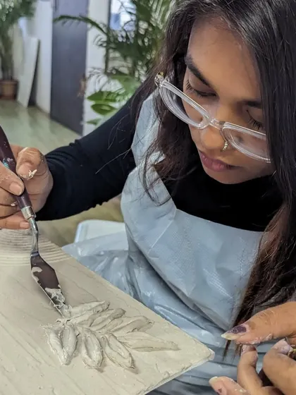 A participant using a palette knife to create a textured sculpture painting. This technique allows for bold, expressive strokes and a lot of dimension.