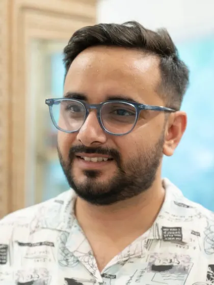 The final result of a great haircut is confidence. This client is all smiles after his transformation, showcasing a modern, clean cut that perfectly suits his style.