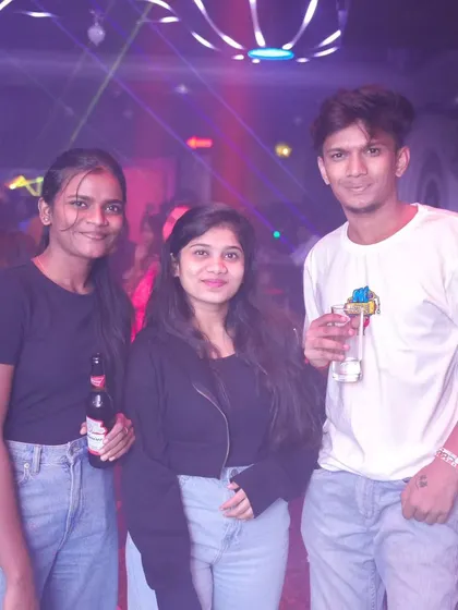 Guests enjoying drinks and the vibrant laser lights. The combination of great music and a cool setting makes for a perfect night.