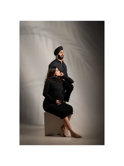 The same maternity portrait in color, highlighting the subtle textures and tones. Being your parents is the greatest blessing, a sentiment beautifully captured in this classic studio shot.