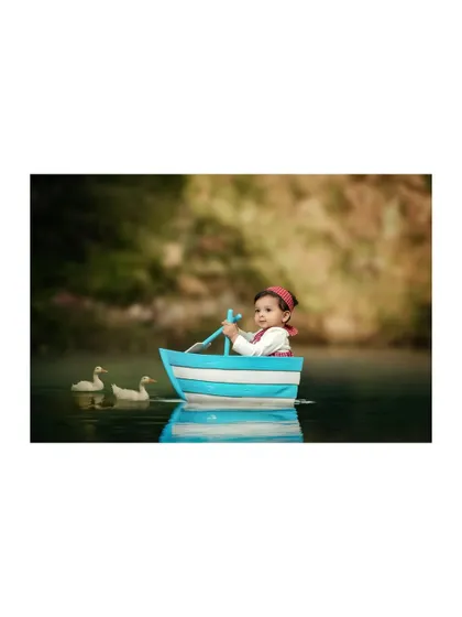 A determined little captain steering his boat. The composite effect creates a dreamy, storybook feel for this unique nautical portrait.