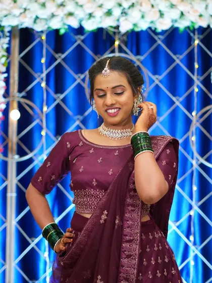 The bride adjusting her earring, a simple, elegant gesture captured candidly. It highlights her jewelry and adds a touch of movement to the portrait.
