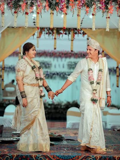 A candid shot of the couple holding hands and sharing a look during their wedding ceremony. A simple moment full of meaning.