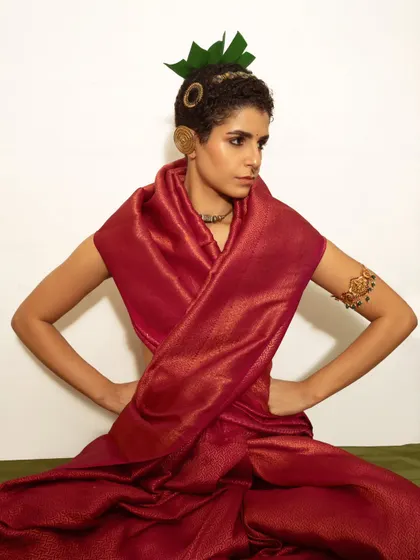 A modern interpretation of traditional aesthetics. The unique styling with a fresh leaf headpiece and rich silk drape creates a portrait that is both classic and contemporary.