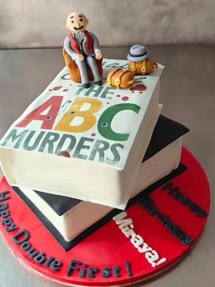 Here's another angle of our Agatha Christie book cake, showing the "Happy Double First Birthday" message. We can personalize any design to fit your unique celebration.