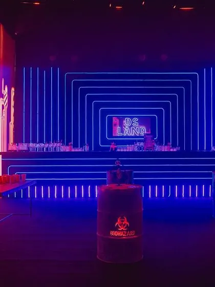 The bar area was designed with a backdrop of concentric blue neon squares, creating a hypnotic effect. We used oil drums as high tables to enhance the industrial, underground theme.