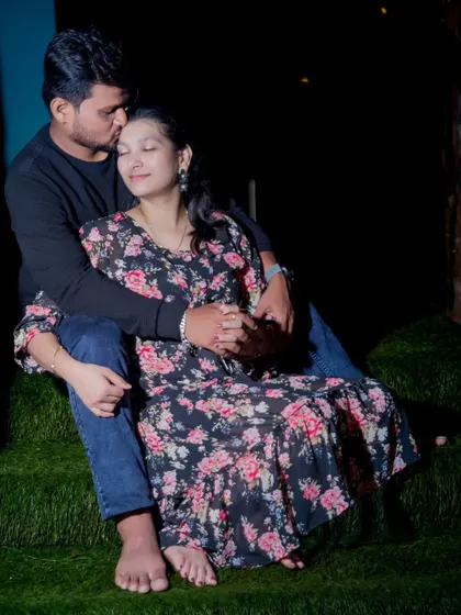 A sweet and cozy pre-wedding portrait taken at night. The groom's gentle kiss on the forehead conveys warmth and affection.