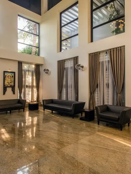The double-height living room in the Eco Terre residence creates a sense of spaciousness and volume. Large windows ensure the area is filled with natural light throughout the day.