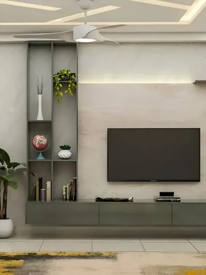 A minimalist TV unit with a grey floating console and a vertical shelving unit for plants and decor. The simple design is set against a light marble-effect wall, creating a calm and uncluttered space.