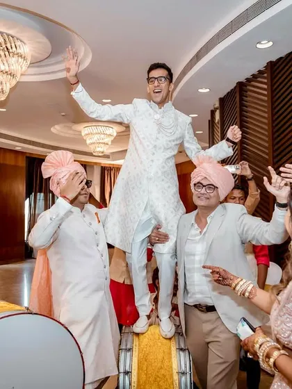 Another high-energy moment with a guest dancing on the dhol, surrounded by a cheering crowd. This is what a great wedding party looks like.