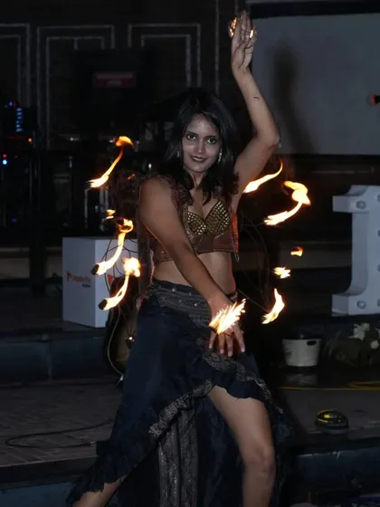 Dancing with fire palm torches for a corporate event. These small, versatile props allow for intricate hand movements and a more personal, up-close style of fire dance.