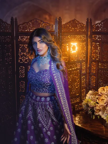 For this look, I styled Sreeleela in a stunning purple lehenga against a carved wooden screen. The cool tones of the outfit and diamond jewelry contrast beautifully with the warm, ambient lighting.