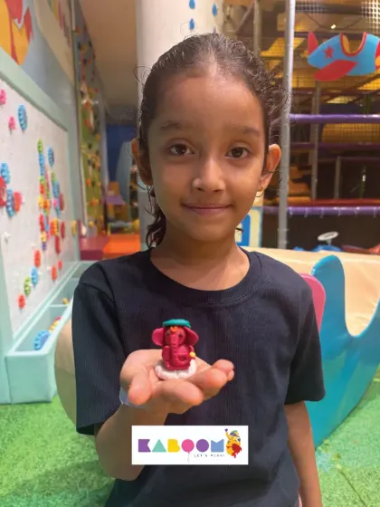 A young artist proudly displays the tiny, detailed Ganesha idol she crafted herself during our festive workshop. It's a wonderful keepsake from a day of creative celebration.