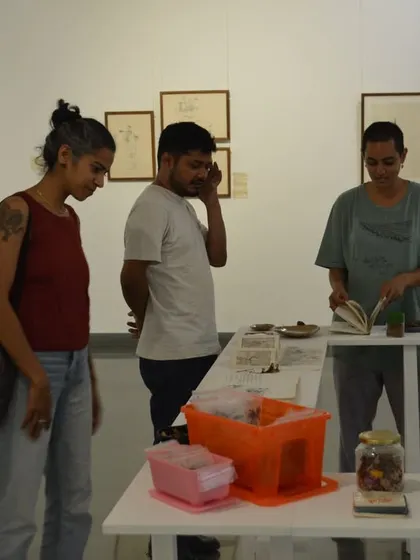 Visitors engaging with the artist's collection of objects, which were central to the narrative of 'Bring me Flowers'.