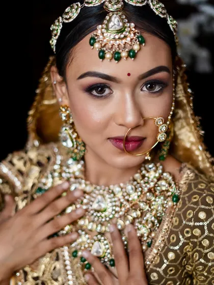 A stunning ethnic bridal look with a focus on dramatic, smoky eyes and heavy, traditional jewelry.