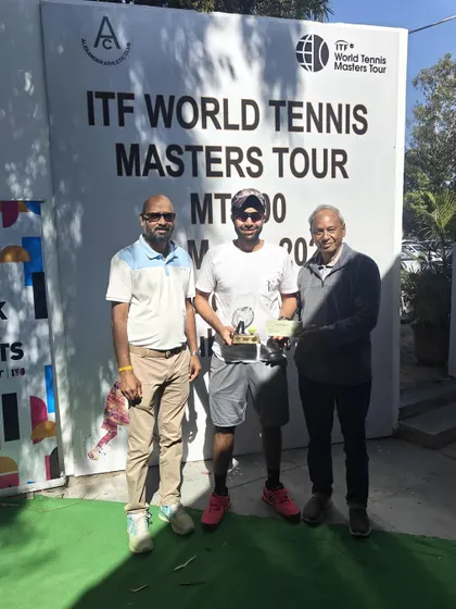 Receiving the winner's trophy at the ITF MT700 tournament. It's always a great feeling to see the hard work translate into a title.