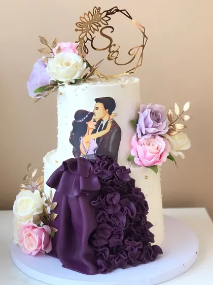 A dramatic two-tiered engagement cake with a custom illustration of the couple. The ruffled purple gown detail is handcrafted from fondant.