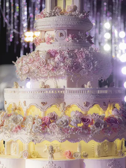 A closer look at the incredible detail on the 8-foot architectural cake. You can see the intricate sugar lace, the delicate floral arrangements, and the soft, internal glow that gives the structure its magical ambiance.