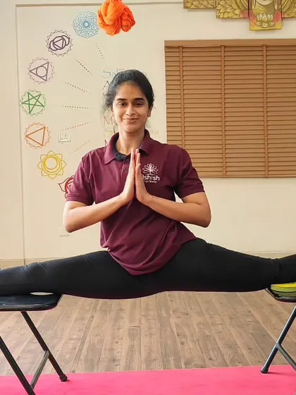 We use props like chairs to make advanced poses more accessible and to deepen flexibility. This student demonstrates incredible control and flexibility in a chair-supported split.