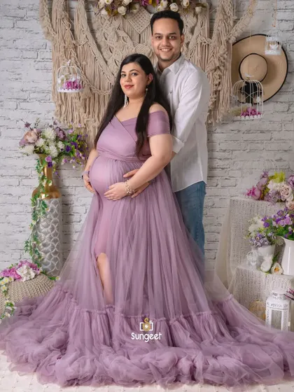 A full-length portrait of a couple in our boho-themed studio. The flowing lavender gown and casual attire of the partner create a lovely contrast.