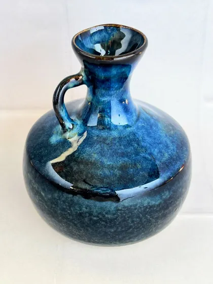 A wheel-thrown vase with a simple, classic shape and a stunning midnight blue glaze.