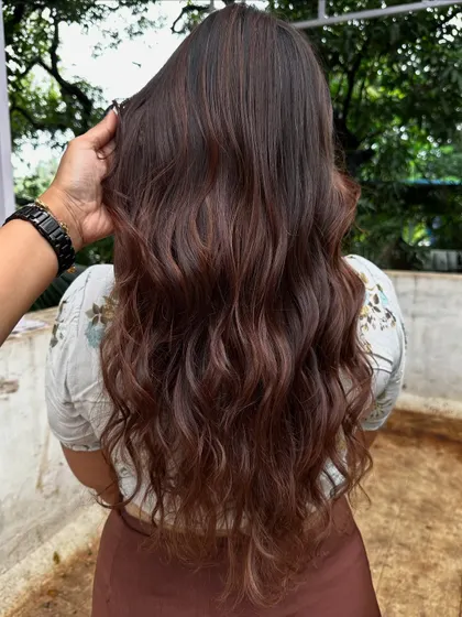 The back view of her elegant wedding guest hair.