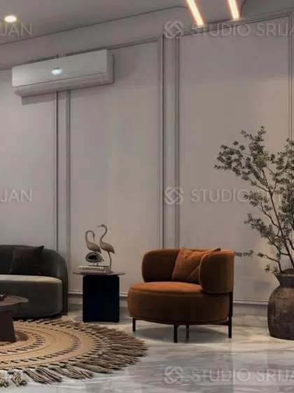 An accent chair in a rich terracotta color adds a pop of warmth to the otherwise neutral and grey-toned lobby in Mansarovar Garden.