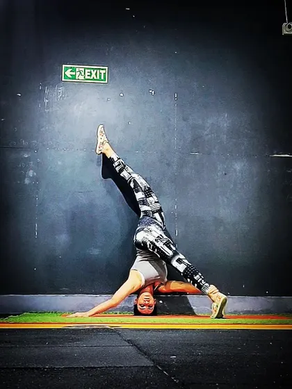 A twisted inversion adds another layer of challenge, requiring deep core strength and balance. This is a variation of Parsva Sirsasana, a great way to play with your limits.
