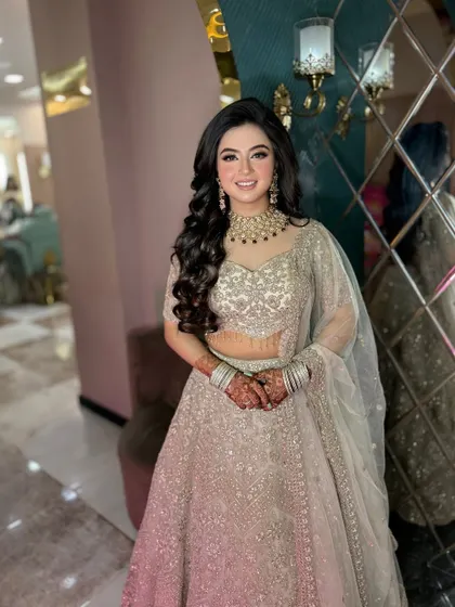 A soft pink glam look for my beautiful client. The silver lehenga is complemented by soft makeup and voluminous curls.