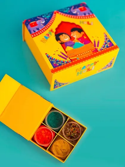 Spread joy with this compact and colorful Holi hamper. It contains four small containers of gulal in a bright yellow, beautifully designed box.