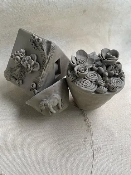 The same beautiful handbuilt sculptures, highlighting the fine details and imaginative forms that students create.