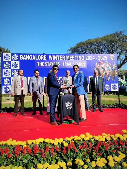 Dr. C.A. Prashanth presents The Stayers' Trial Stakes trophy to the winning connections of Queen of Kings.