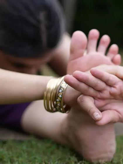 A close-up of a deep forward bend, Paschimottanasana. Asana practice is a preparation, releasing tension and building strength to set the stage for the deeper work of pranayama and meditation.