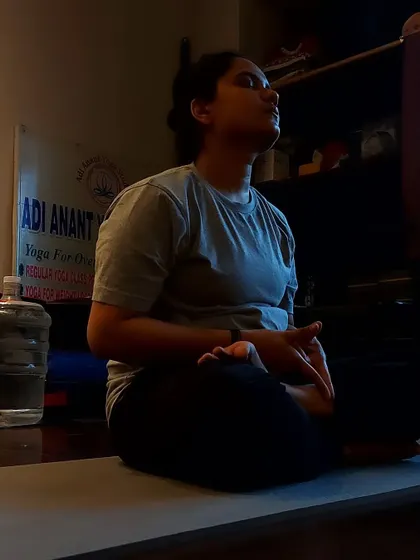 A close-up of a student in meditation, practicing Yoni Mudra to connect with their inner energy.