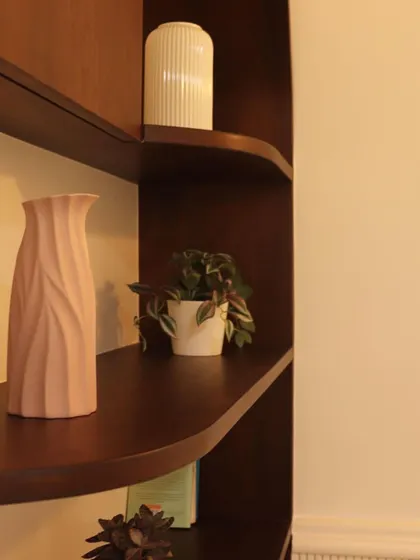A detail shot of elegantly styled shelves, showing how a few well-placed decor items can complete a space.