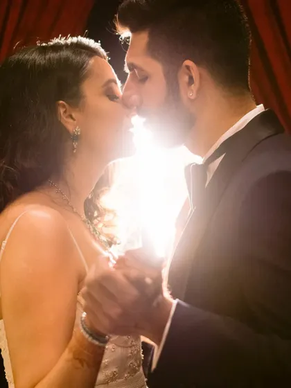 A close-up, backlit shot of the couple about to kiss, creating a beautiful, glowing silhouette that emphasizes their passion and intimacy.