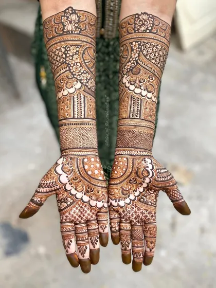 A complete view of a heavy, intricate mehendi design. The patterns are dense and detailed, perfect for a bride or for a grand celebration.