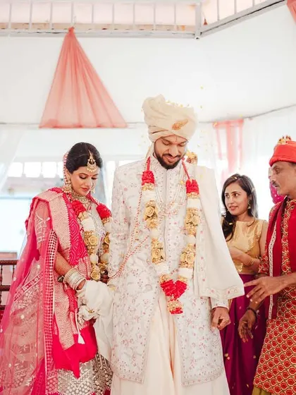 The couple taking their first steps together as husband and wife during the pheras.