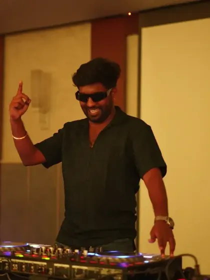 Pointing to the sky and feeling the vibe. A great DJ reads the room and becomes one with the crowd's energy.